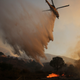 A helicopter makes a drop in Santa Clarita on Sunday. (AP/Ringo H.W. Chiu)